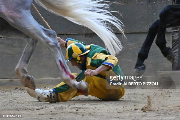 Italian jockey Stefano Piras, who races for the "Bruco" district, falls during a false start of his horse "Uragano Rosso" during the historical...