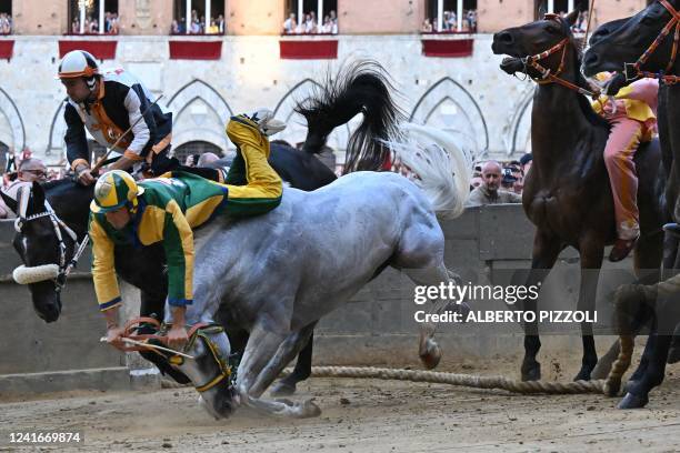 Italian jockey Stefano Piras , who races for the "Bruco" district, falls during a false start of his horse "Uragano Rosso" during the historical...