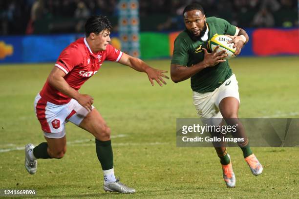 Lukhanyo Am of the Springboks takes on Louis Rees-Zammit of Wales during the first test match of the 2022 Castle Lager Incoming Series between South...