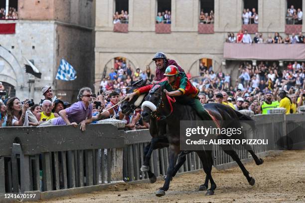 Italian jockey Giovanni Atzeni riding Zio Frac for the Drago district, and Italian jockey Jonatan Bartoletti riding Viso d'Angelo for the Torre...