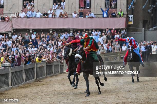 Italian jockey Jonatan Bartoletti riding Viso d'Angelo for the Torre ditrict, Italian jockey Giovanni Atzeni riding Zio Frac for the Drago district,...