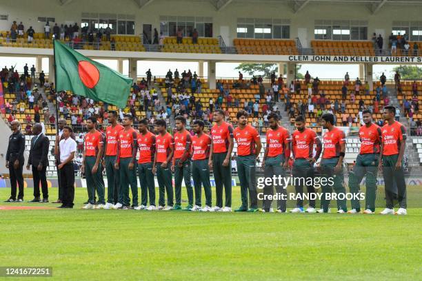 Members of the Bangladesh team stand at attention for the playing of the national anthem during the first T20I between West Indies and Bangladesh at...