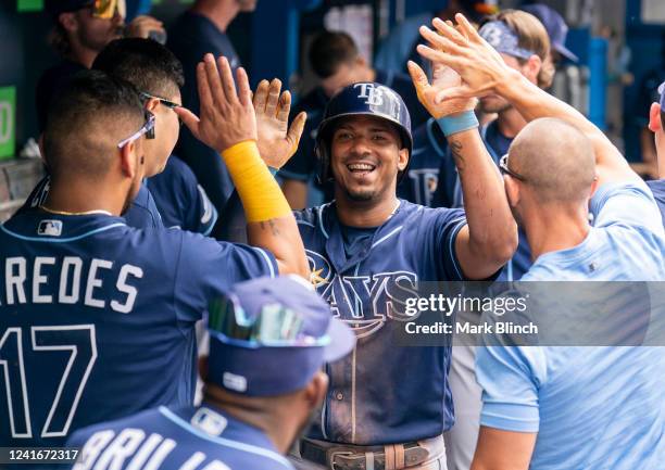 Wander Franco of the Tampa Bay Rays celebrates in the dugout after his home run against the Toronto Blue Jays in the fifth inning during game one of...