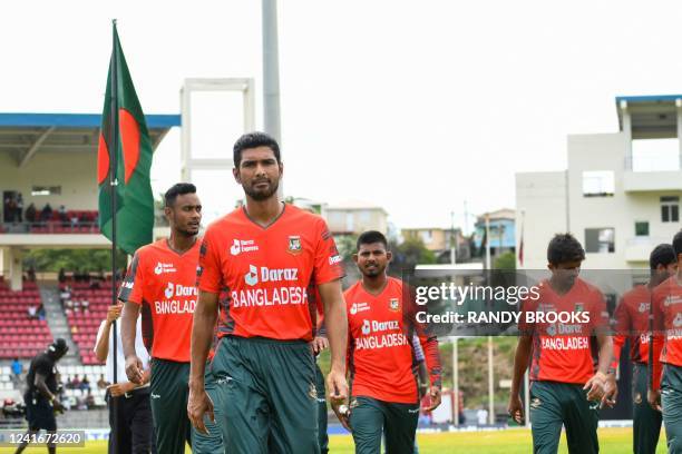 Mahmudullah , Shoriful Islam and Musaddek Hossain Saikat , of Bangladesh, walk off the field following the playing of the national anthem during the...