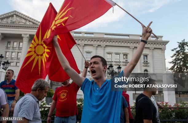 People shout slogans and wave flags during the protest in front of governamet building on under the slogan Ultimatum no thanks in Skopje on July 2,...