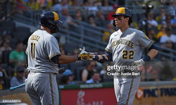 Christian Yelich of the Milwaukee Brewers celebrates with Rowdy Tellez after hitting a solo home run in the fifth inning during the game against the...