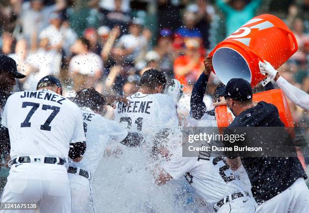 Riley Greene of the Detroit Tigers celebrates with teammates after hitting a walk-off home run to defeat the Kansas City Royals 4-3 during the ninth...