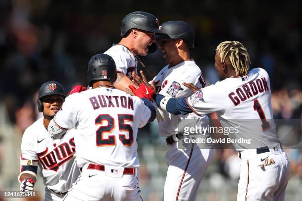 Jose Miranda of the Minnesota Twins, center left, celebrates his walk off single with teammates against the Baltimore Orioles in the ninth inning of...