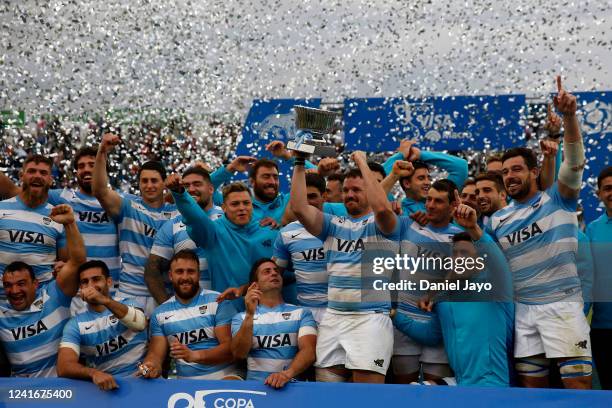 Julian Montoya of Argentina holds up the trophy as he celebrates with teammates at the end of a test match between Argentina and Scotland at Estadio...