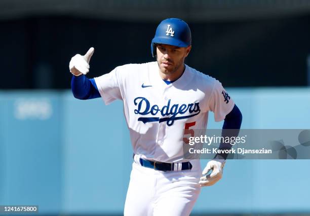 Freddie Freeman of the Los Angeles Dodgers celebrates after hitting a one run home run against starting pitcher Yu Darvish of the San Diego Padres...