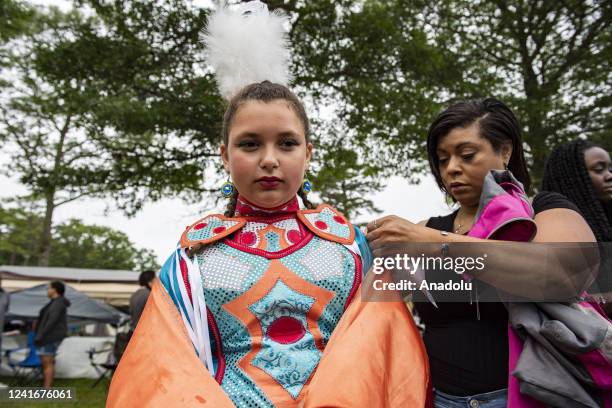 Woman helps dress a young dancer during the Mashpee Wampanoagâââââââ Tribe's 101st annual Powwow in Mashpee, Massachusetts on July 2, 2022. This is...