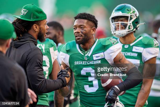 Nick Marshall of the Saskatchewan Roughriders is congratulated on the sideline after returning an interception for a touchdown in the game between...