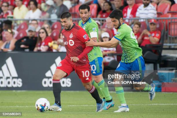 Alejandro Pozuelo and Dylan Teves in action during the MLS game between Toronto FC and Seattle Sounders FC at BMO field in Toronto. The game ended...