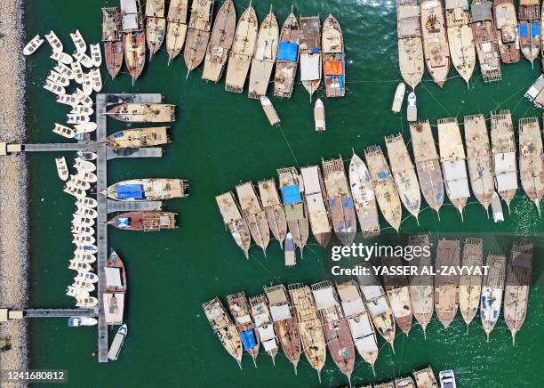 An aerial view shows traditional fishing boats docked at the Souq sharq harbour, in Kuwait City on July 3, 2022.