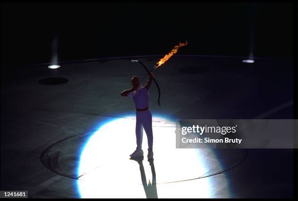 Paralympic archer Antonio Rebollo shooting lit arrow and lighting flame at Olympic Stadium, Barcelona, Spain 7/25/1992