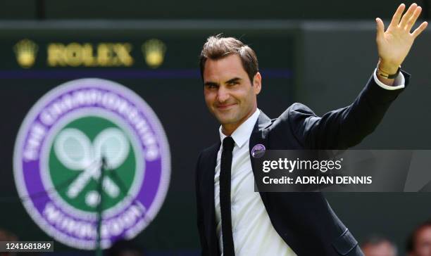 Swiss tennis player Roger Federer waves during the Centre Court Centenary Ceremony, on the seventh day of the 2022 Wimbledon Championships at The All...