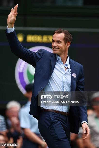 Britain's former winner of Wimbledon Tournament, Andy Murray, waves as he takes part in the Centre Court Centenary Ceremony, on the seventh day of...