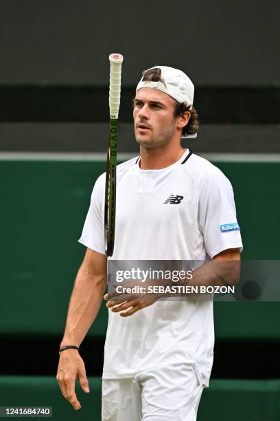 Player Tommy Paul plays with his racket during his round of 16 men's singles tennis match against Britain's Cameron Norrie on the seventh day of the...