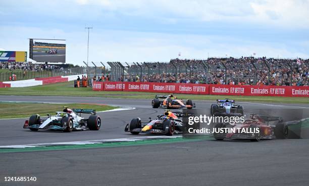 Ferrari's Monegasque driver Charles Leclerc and Red Bull Racing's Mexican driver Sergio Perez run wide allowing Mercedes' British driver Lewis...