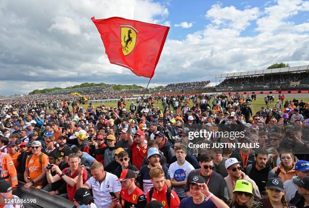 Ferrari fan waves a giant flag after the Formula One British Grand Prix at the Silverstone motor racing circuit in Silverstone, central England on...