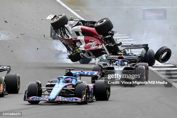 Zhou Guanyu of China driving the Alfa Romeo F1 C42 Ferrari crashes at the start of the race during the F1 Grand Prix of Great Britain at Silverstone...