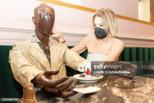 Fashion designer Inés Penelas poses next to a dressed mannequin to show the latest fashion trends while ensuring social distancing in the cafeteria...