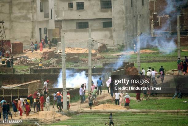 Local residents clash with police personnel during an anti-encroachment drive at Nepali Nagar on July 3, 2022 in Patna, India. A clash ensued between...