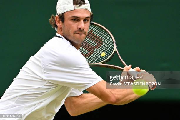 Player Tommy Paul eyes the ball as he returns it to Britain's Cameron Norrie during their round of 16 men's singles tennis match on the seventh day...
