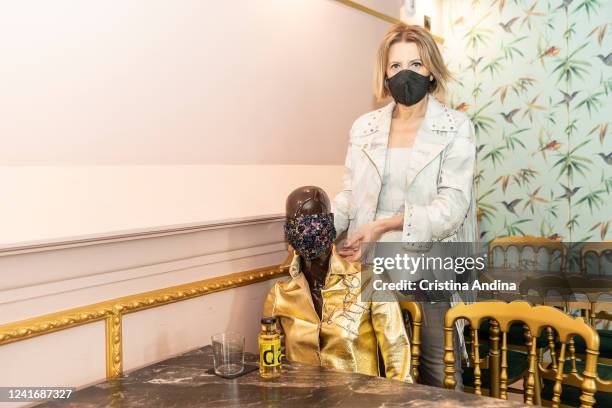 Fashion designer Inés Penelas poses next to a dressed mannequin to show the latest fashion trends while ensuring social distancing in the cafeteria...