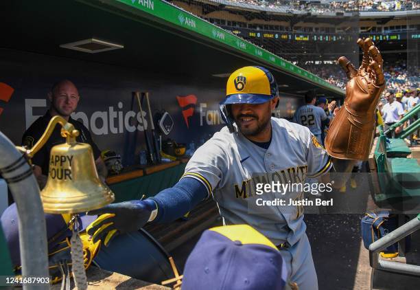 Omar Narvaez of the Milwaukee Brewers celebrates in the dugout while wearing an Infinity Gauntlet from Marvel Comics after hitting a two-run home run...