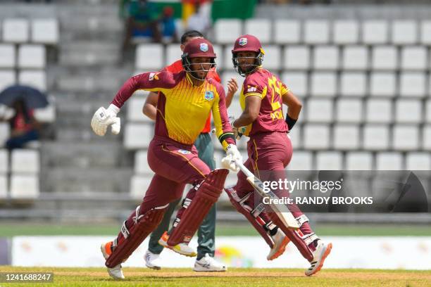 Brandon King and Nicholas Pooran , of West Indies, celebrate their 50 runs partnership during the second T20I between West Indies and Bangladesh at...