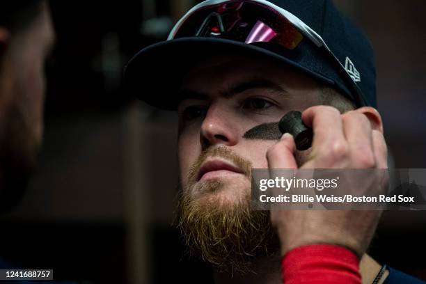 Christian Arroyo of the Boston Red Sox applies eye black before a game against the Chicago Cubs on July 3, 2022 at Wrigley Field in Chicago, Illinois.