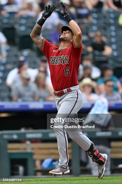 David Peralta of the Arizona Diamondbacks celebrates as he runs the bases after hitting a fifth inning grand slam home run against the Colorado...