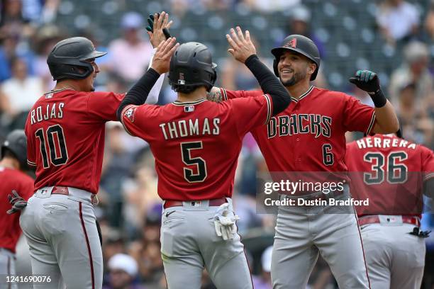 David Peralta of the Arizona Diamondbacks celebrates with Josh Rojas, Alek Thomas, and Jose Herrera after hitting a fifth inning grand slam home run...