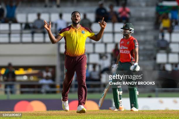 Romario Shepherd, of West Indies, celebrates the dismissal of Musaddek Hossain Saikat, of Bangladesh, during the second T20I between West Indies and...