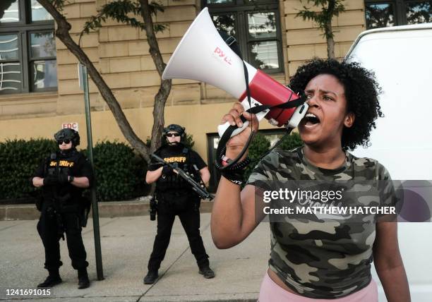 Members of the Sheriff's department stand in riot gear as demonstrators gather outside Akron City Hall to protest the killing of Jayland Walker, shot...