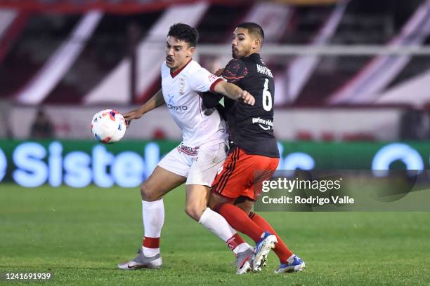 Hector Martinez of River Plate fights for the ball with Matias Coccaro of Huracan during a match between Huracan and River Plate as part of Liga...