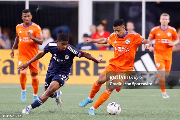 Cincinnati center forward Brenner cuts away from New England Revolution midfielder Lucas Maciel Felix during a match between the New England...