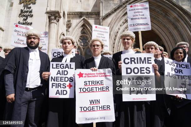 Criminal defence barristers gather outside the Royal Courts of Justice in London to support the ongoing Criminal Bar Association action over...