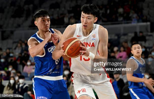 China's Zhou Qi is challenged by Taiwan's Chen Chao Hao during the FIBA Basketball World Cup 2023 qualifying game between China and Taiwan in...