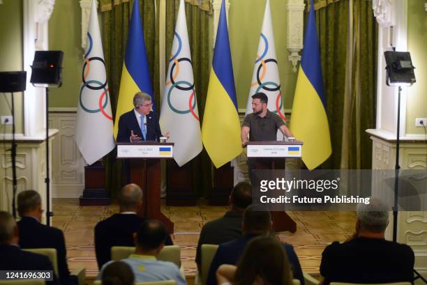 President of the International Olympic Committee Thomas Bach and President of Ukraine Volodymyr Zelenskyy are pictured during a joint briefing, Kyiv,...