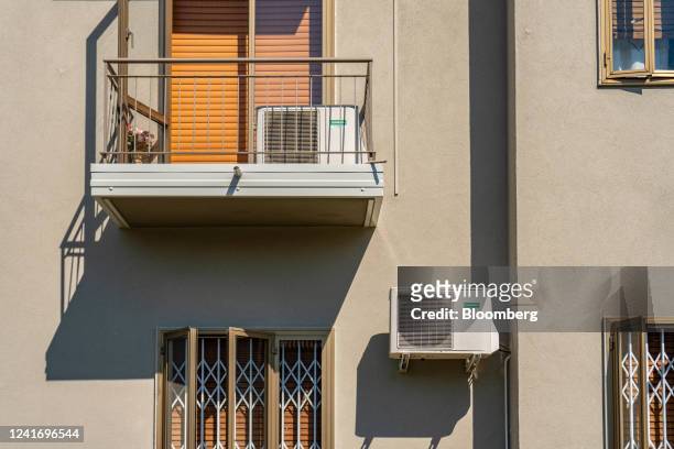 Air conditioning units on the facade of residential houses in Brescia, Italy, on Sunday, July 3, 2022. Italy's government plans further measures to...