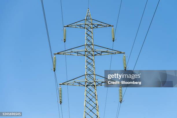 An electricity transmission tower and power lines in Brescia, Italy, on Sunday, July 3, 2022. Italy's government plans further measures to cushion...