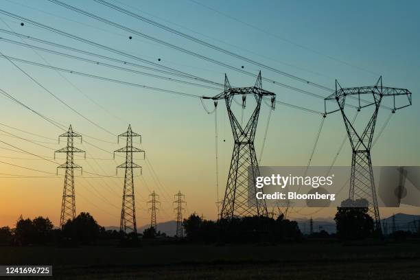 Electricity transmission towers and power lines in Brescia, Italy, on Sunday, July 3, 2022. Italy's government plans further measures to cushion the...