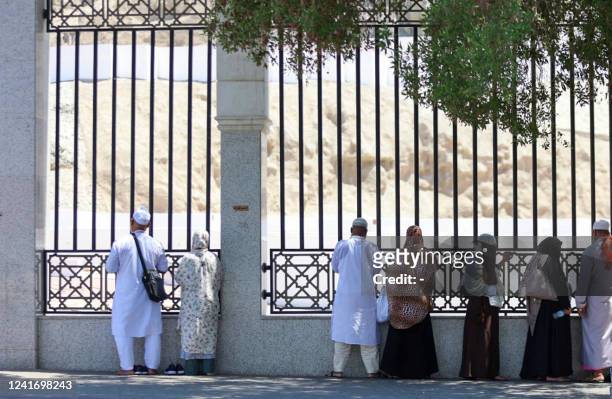 Muslim pilgrims are pictured outside the Jannat al-Mualla, also known as the "Cemetery of Mala", in the holy city of Mecca on July 4 as Saudi Arabia...