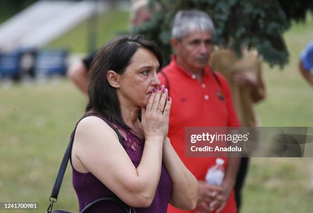 People attend a funeral ceremony of a football coach and director of a children's and youth club Oleksandr Shyshkov who died during the recent...