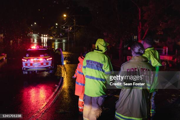 State Emergency Service and Rural Fire Brigade volunteers are seen during the evacuation of residents from the Woronora River area as floodwaters...