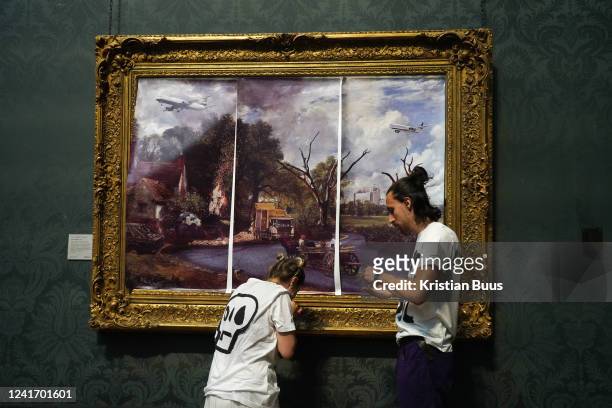 Just Stop Oil climate activists subvert The Hay Wain painting by John Constable and glue themselves to the frame at the National Gallery on the 4th...