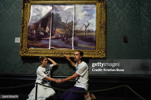 Just Stop Oil climate activists subvert The Hay Wain painting by John Constable and glue themselves to the frame at the National Gallery on the 4th...