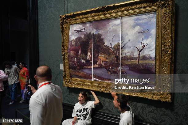 Just Stop Oil climate activists subvert The Hay Wain painting by John Constable and glue themselves to the frame at the National Gallery on the 4th...